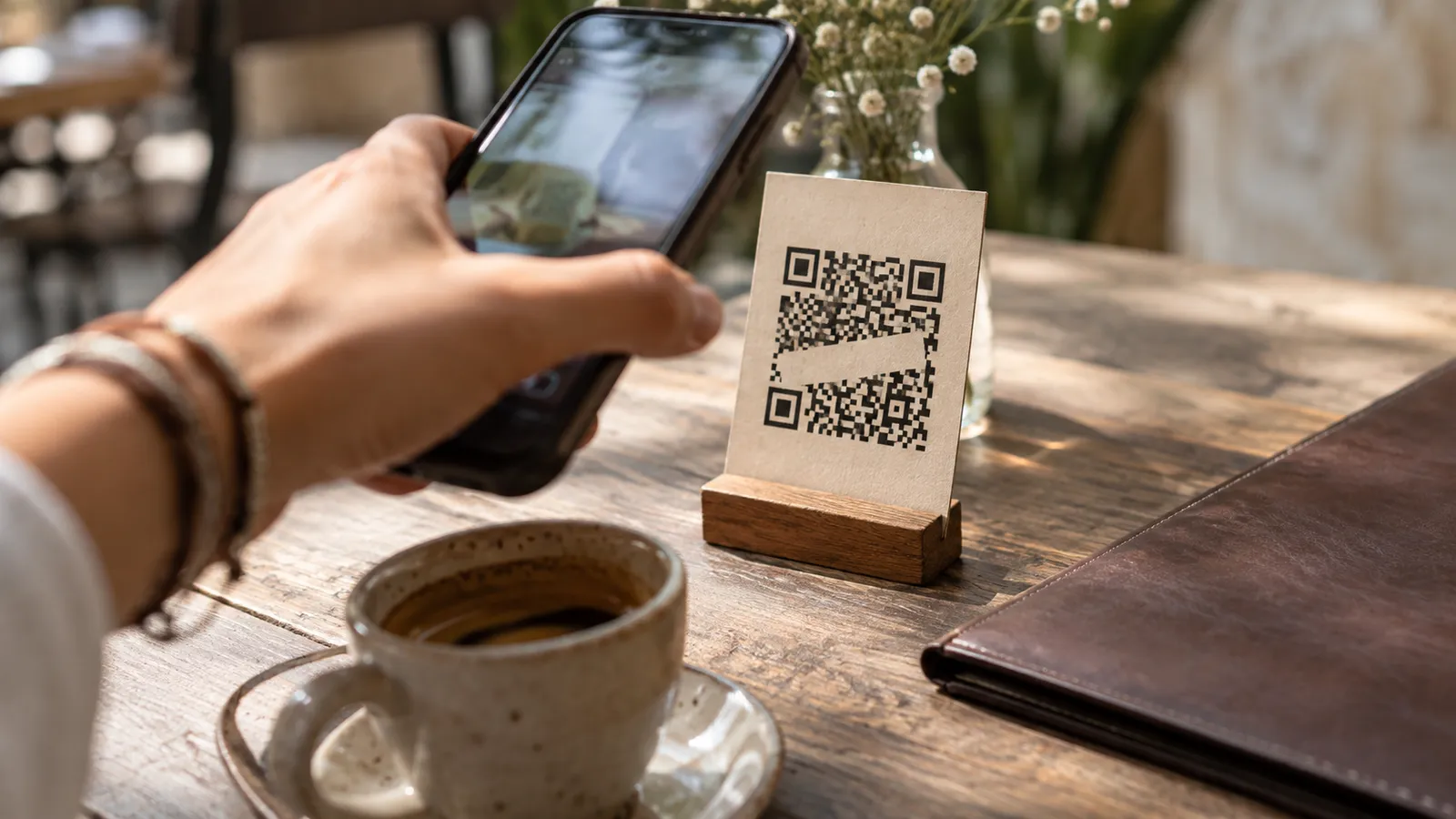 A phone in front of an illustrative QR card on a table. AI-generated illustration.